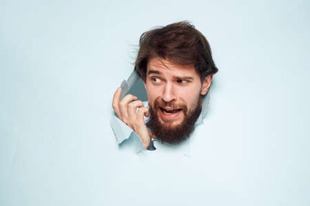 screaming bearded man peeking out from behind the wall emotions work