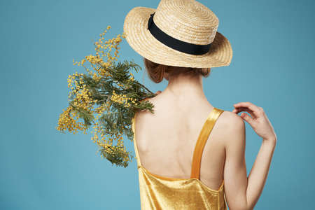 Woman wearing a bouquet of flowers hat back view lifestyle