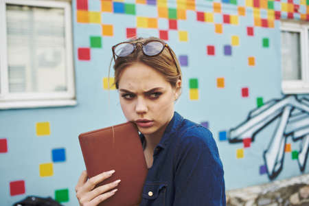 Business woman with notepad in hands background.の写真素材