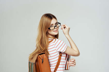 Female student with notepad and glasses.