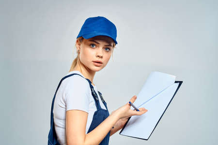 Woman courier in uniform documents service deliveryの写真素材