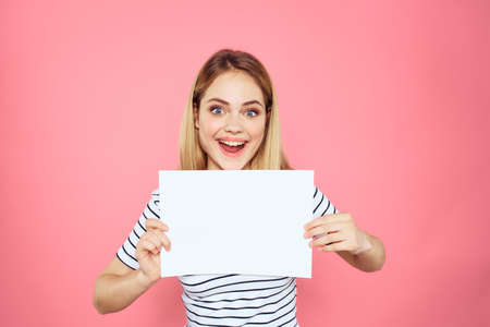 woman holding white sheet in her hands striped t-shirt emotions pink background