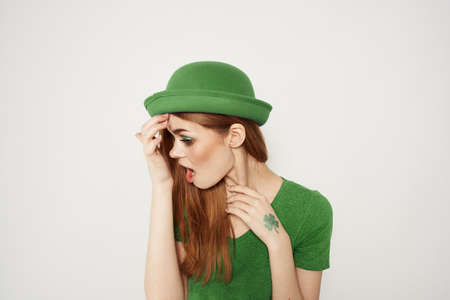 happy woman in green clothes in st patricks day shamrock hat makeup modelの写真素材