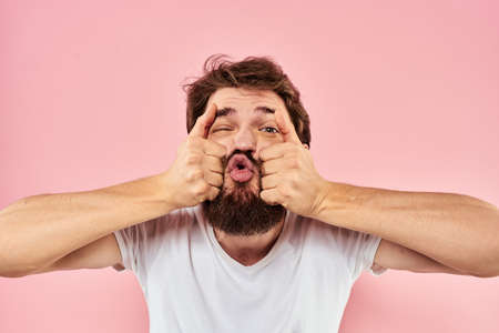 Bearded man white t-shirt cropped view lifestyle studio pink backgroundの写真素材