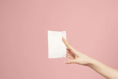 Laying in packaging in female hands on a pink background cropped view hygiene clean appearanceの写真素材