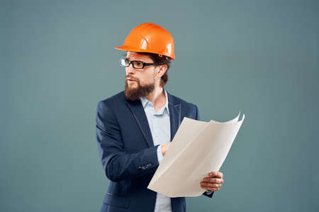 Male engineer with blueprints in the hands of an orange hard hat Industry professionalの写真素材
