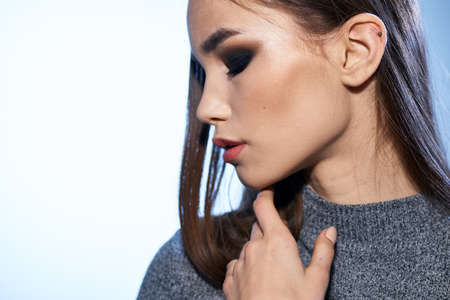 Pretty woman in gray sweater bright makeup long hair charm cropped view