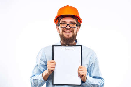 A man in an orange hard hat with documents Industrial activity workの写真素材