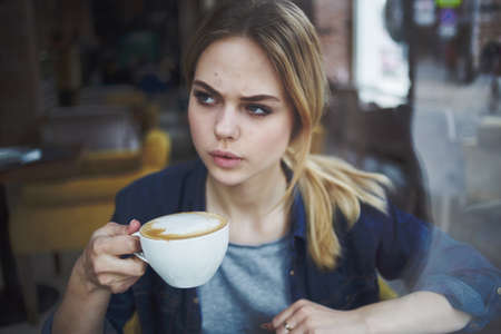 woman drinking coffee rest morning snack restaurantの写真素材