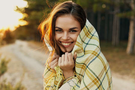 Cheerful woman in plaid blanket outdoors cropped view of fresh air