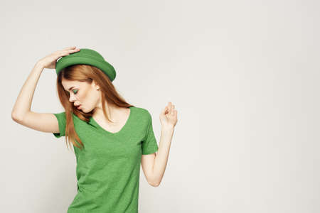 girl in green clothes with hat on light background St. Patricks day cropped viewの写真素材