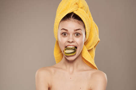 cheerful woman with bare shoulders towel on her head clean skin health kiwi freshness