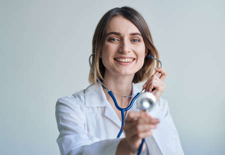 nurse in a medical gown and a stethoscope around her neck smile portrait