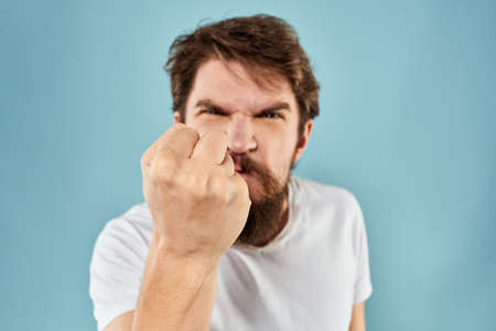 Bearded man emotions facial expression gestures hands close-up blue background