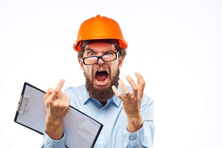 Emotional man in orange paint documents construction Manual drawings engineer