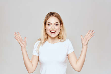 Cute blonde white t-shirt gesture with hands lifestyle light background