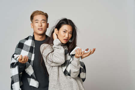 Upset girl and a young guy with a plaidの写真素材