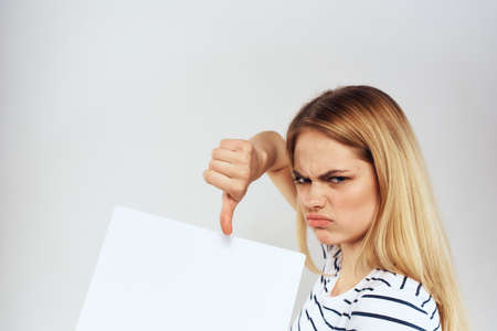 woman holding a sheet of paper in her hands lifestyle striped t-shirt cropped view Copy Spaceの写真素材