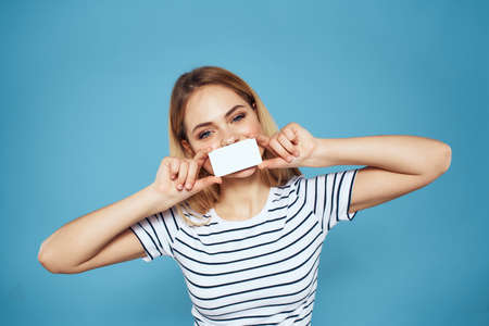 Woman holding business card emotions cropped blue backgroundの写真素材
