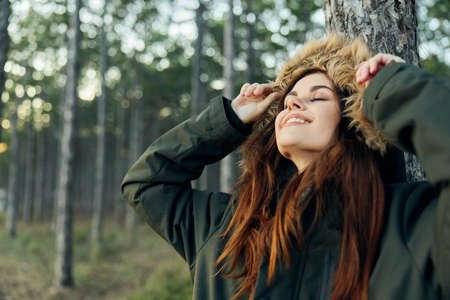 woman in jacket outdoors near tree lifestyle freedom travel