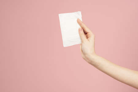 Laying in packaging in female hands on a pink background cropped view hygiene clean appearanceの写真素材