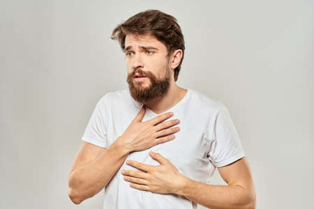 man in white t-shirt gesturing with his hands studio dissatisfaction lifestyle light backgroundの写真素材