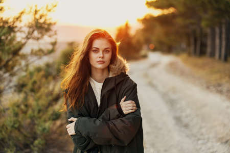 Woman in warm jacket outdoors cool fresh air walkの写真素材