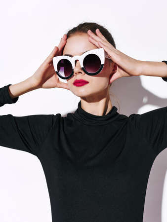 Woman in sunglasses and a black sweater