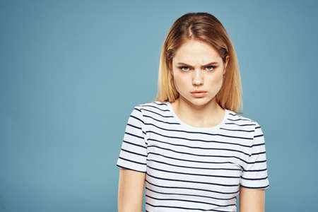 Blonde girl in striped t-shirt lifestyle blue background funの写真素材