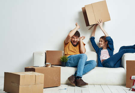 Young married couple room interior cardboard boxes movingの写真素材