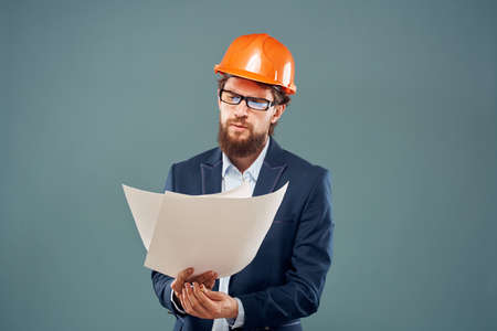 Emotional man in orange coloring drawings instruction manual construction workの写真素材