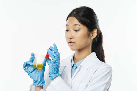 Professional doctor woman with tests in a jar of yellow urine