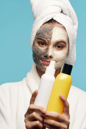 Mask against blackheads on the womans face with a jar of lotion moisturizerの写真素材