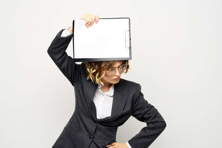Business woman with a folder of documents on a light background cropped view and shirt suitの写真素材