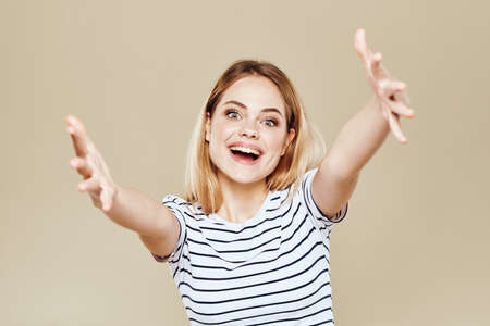 Cute blonde striped t-shirt smile lifestyle beige studio backgroundの写真素材