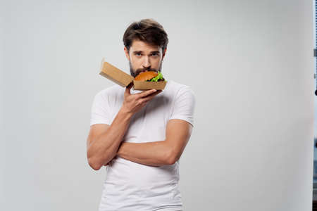 Man with box of hamburger model fast food calorie portraitの写真素材