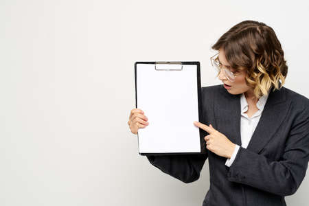 Woman in business suit finances work documents glasses hairstyle. High quality photoの写真素材