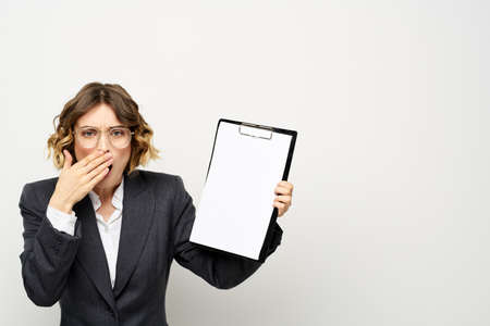 Business woman with a folder of documents on a light background cropped view and shirt suitの写真素材