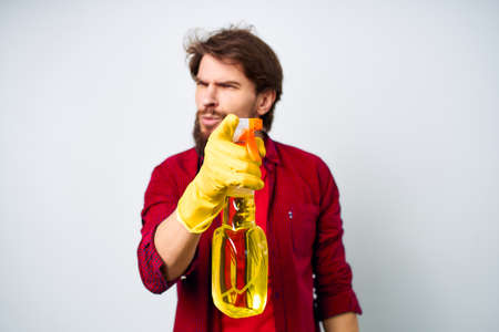 Male professional detergent cleaning service light backgroundの写真素材