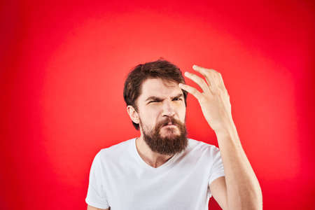 Emotional bearded man with red backgroundの写真素材
