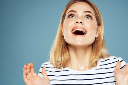 Blonde girl in striped t-shirt lifestyle blue background funの写真素材