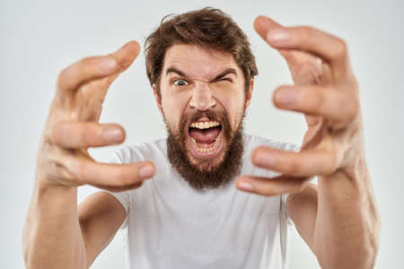 emotional man with a beard gesturing with his hands close-up studio aggressionの写真素材