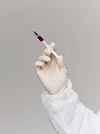 laboratory hand in medical glove vaccine treatment research