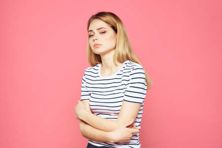Woman in striped t-shirt emotions studio cropped view lifestyle pink isolated backgroundの写真素材