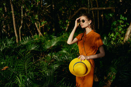 Woman on the island in the park among green bushesの写真素材