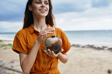 Happy traveler on the island with coconut in her hand natural juiceの写真素材
