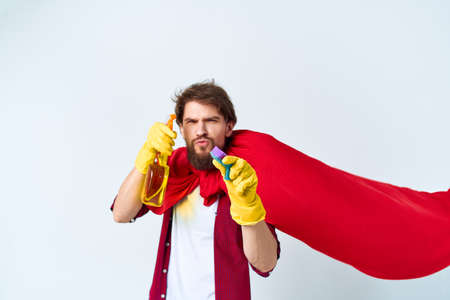 Man yellow rubber gloves cloak household cleaning help around the houseの写真素材