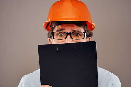 man in work uniform orange helmet service professional operation manualの写真素材