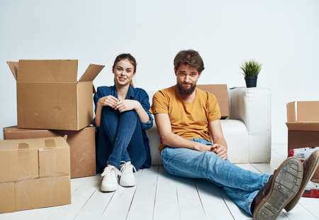 A man and a woman with boxes are moving. Well, an apartment is being renovated by a familyの写真素材