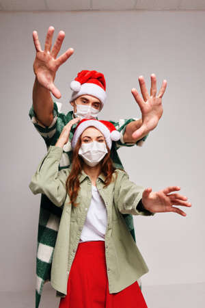 Man and woman in medical masks isolated holiday funの写真素材